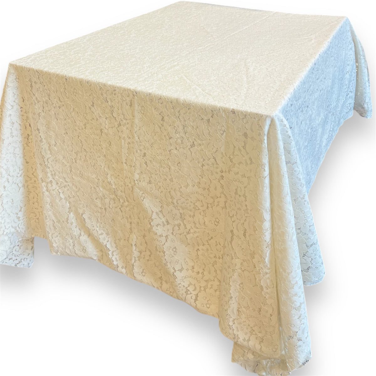 A beige tablecloth with a floral lace pattern draped over a table.