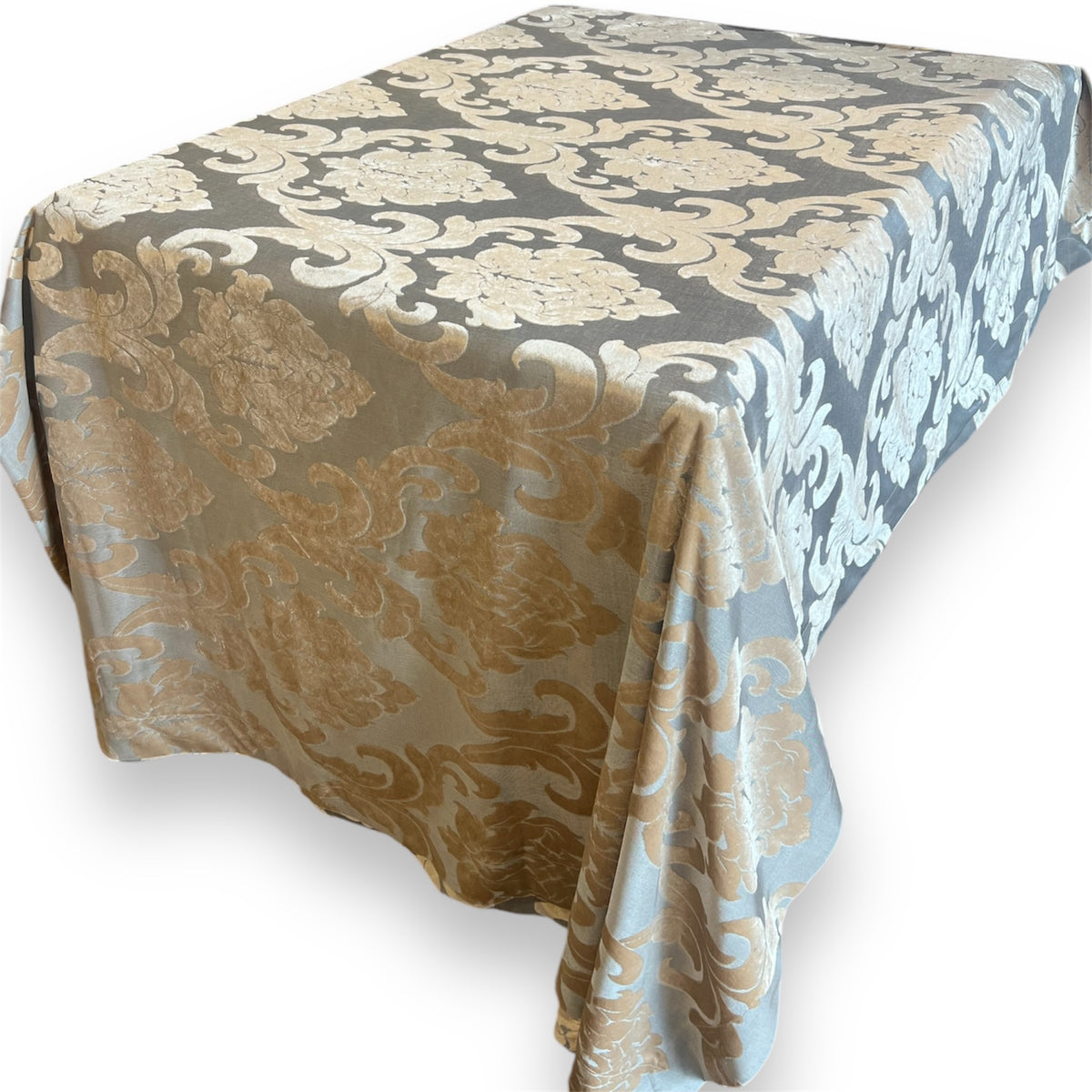 Rectangular tablecloth featuring a prominent gold and soft blue floral damask pattern draped over a table against a plain white background.