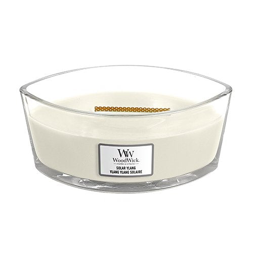 A square-shaped, beige-colored jar candle with an opened lid, labeled 'Woodwick Ylang Square'.