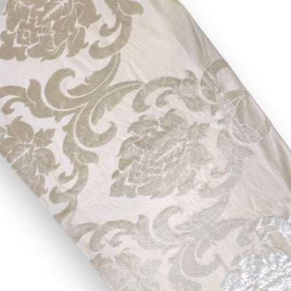 A beige runner with a floral patterned design.