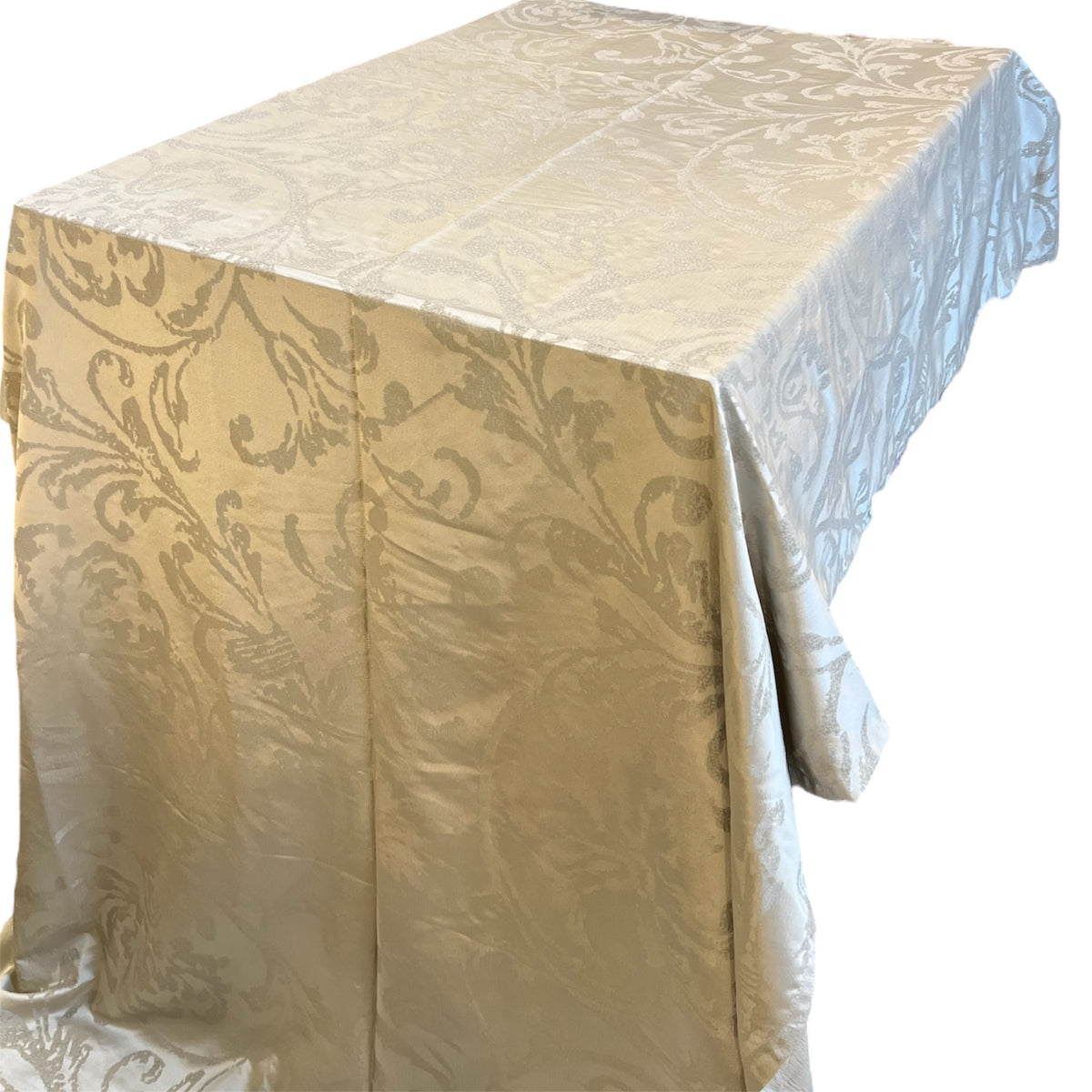 A beige tablecloth with a floral pattern draped over a table.