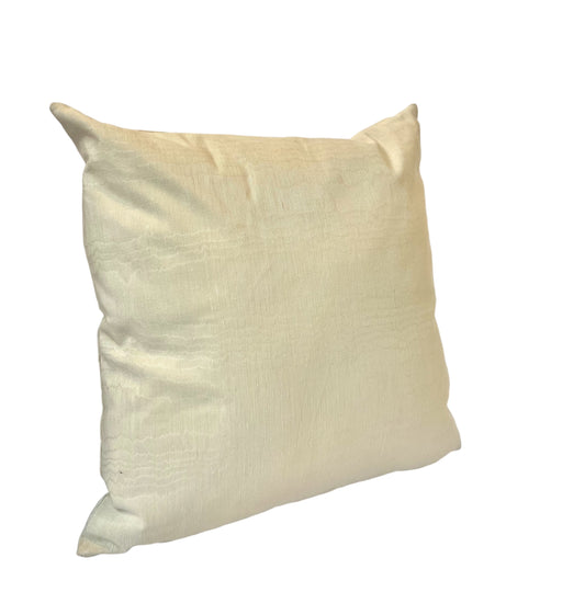 A beige satin pillow with a smooth texture.