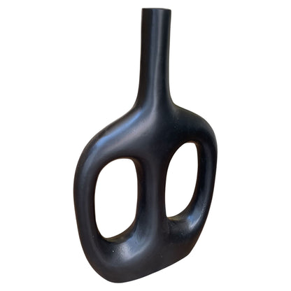 Black vase with unique design on a white background