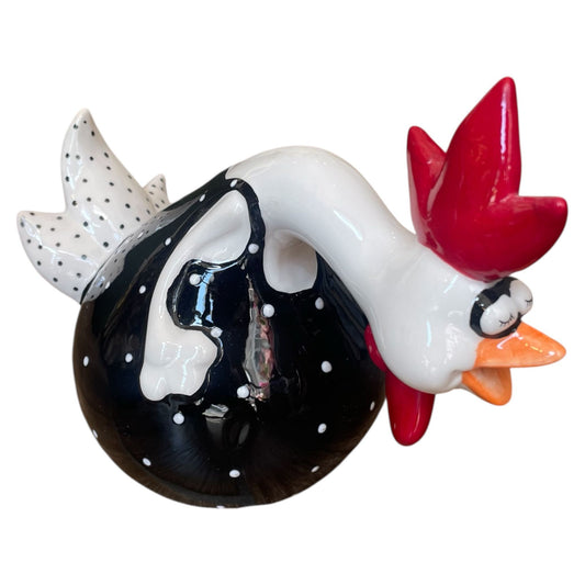 Decorative rooster figurine with a black body, white polka dots, red comb, and orange beak on a white background.