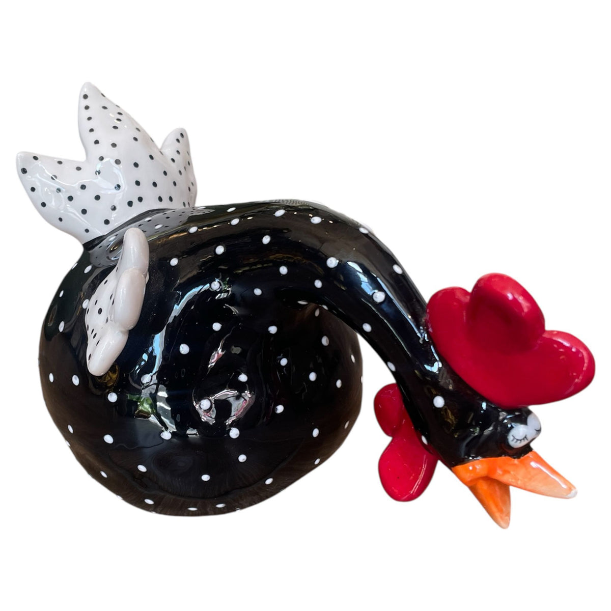Decorative glass rooster with black body, white polka dots, red comb, and orange beak on a white background.