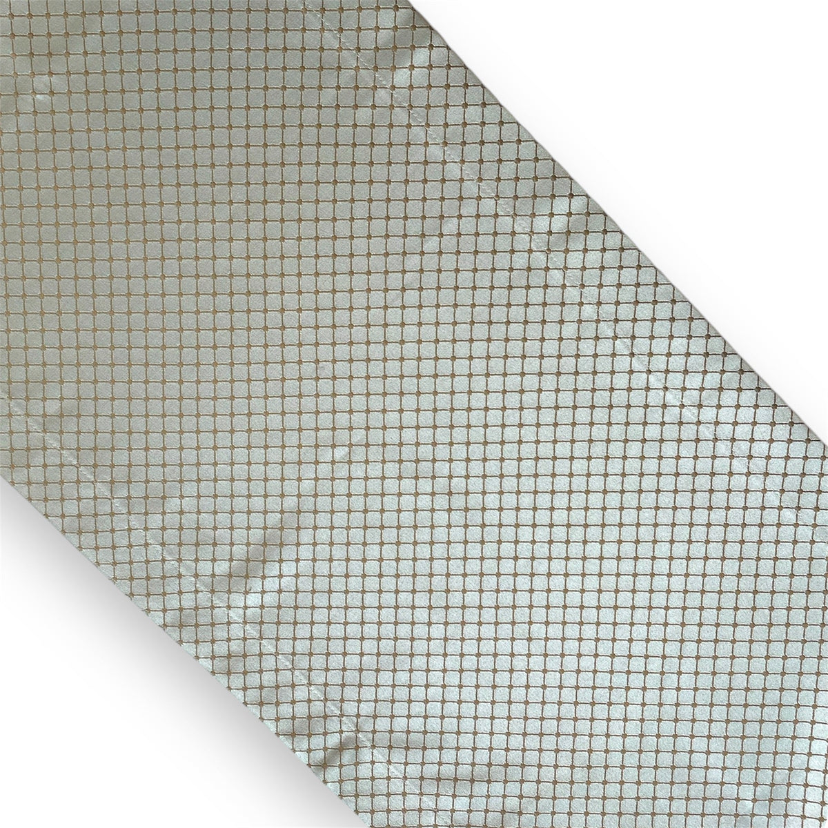 A geometric patterned table runner in blue and gold colors.