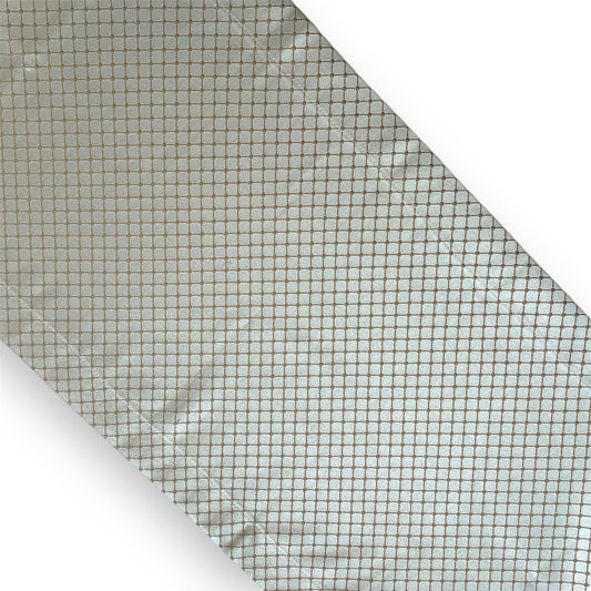 A geometric patterned table runner in blue and gold colors.