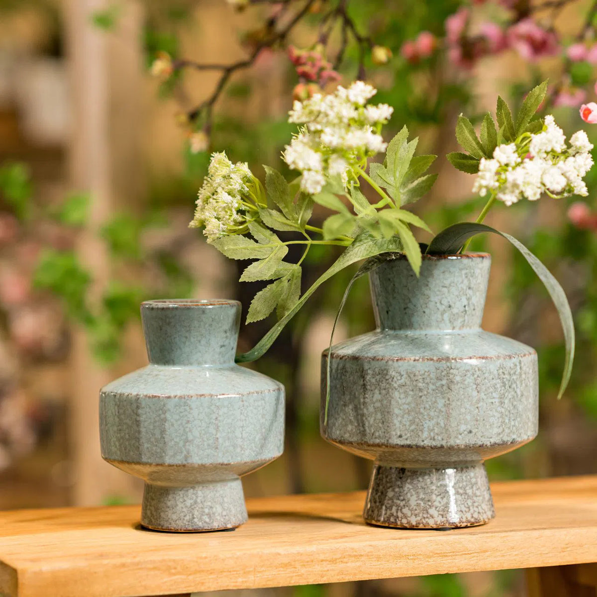 Tall glossy ceramic vase featuring a gradient glaze transitioning from vibrant blue at the top to mossy green at the base.
