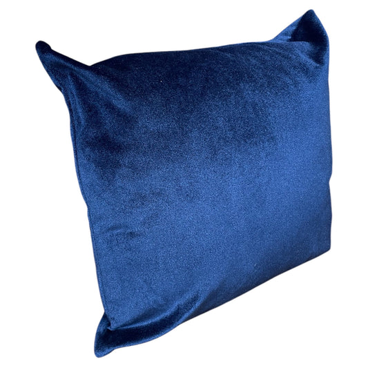 A blue square pillow with a plush texture.