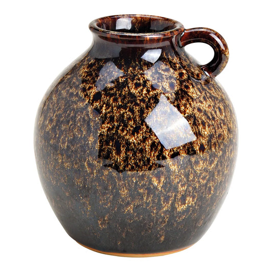 A brown ceramic pitcher vase with a handle and a lid, featuring a solid color and textured design.