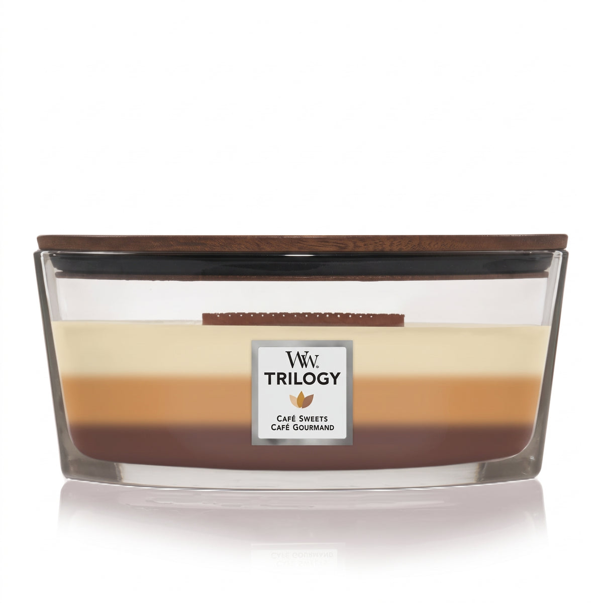 WoodWick Café Sweets Trilogy candle in a clear glass jar with a wooden lid.