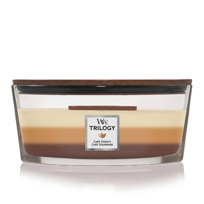 WoodWick Café Sweets Trilogy candle in a clear glass jar with a wooden lid.