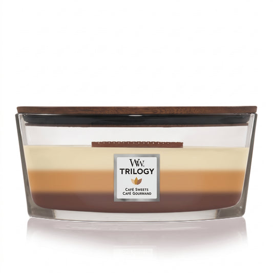 WoodWick Café Sweets Trilogy candle in a clear glass jar with a wooden lid.