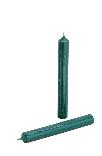 Vibrant Dark Green wax taper candle standing upright in a beige ribbed ceramic holder against a white background.