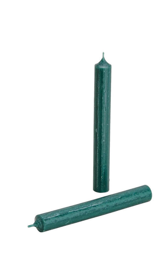 Vibrant Dark Green wax taper candle standing upright in a beige ribbed ceramic holder against a white background.