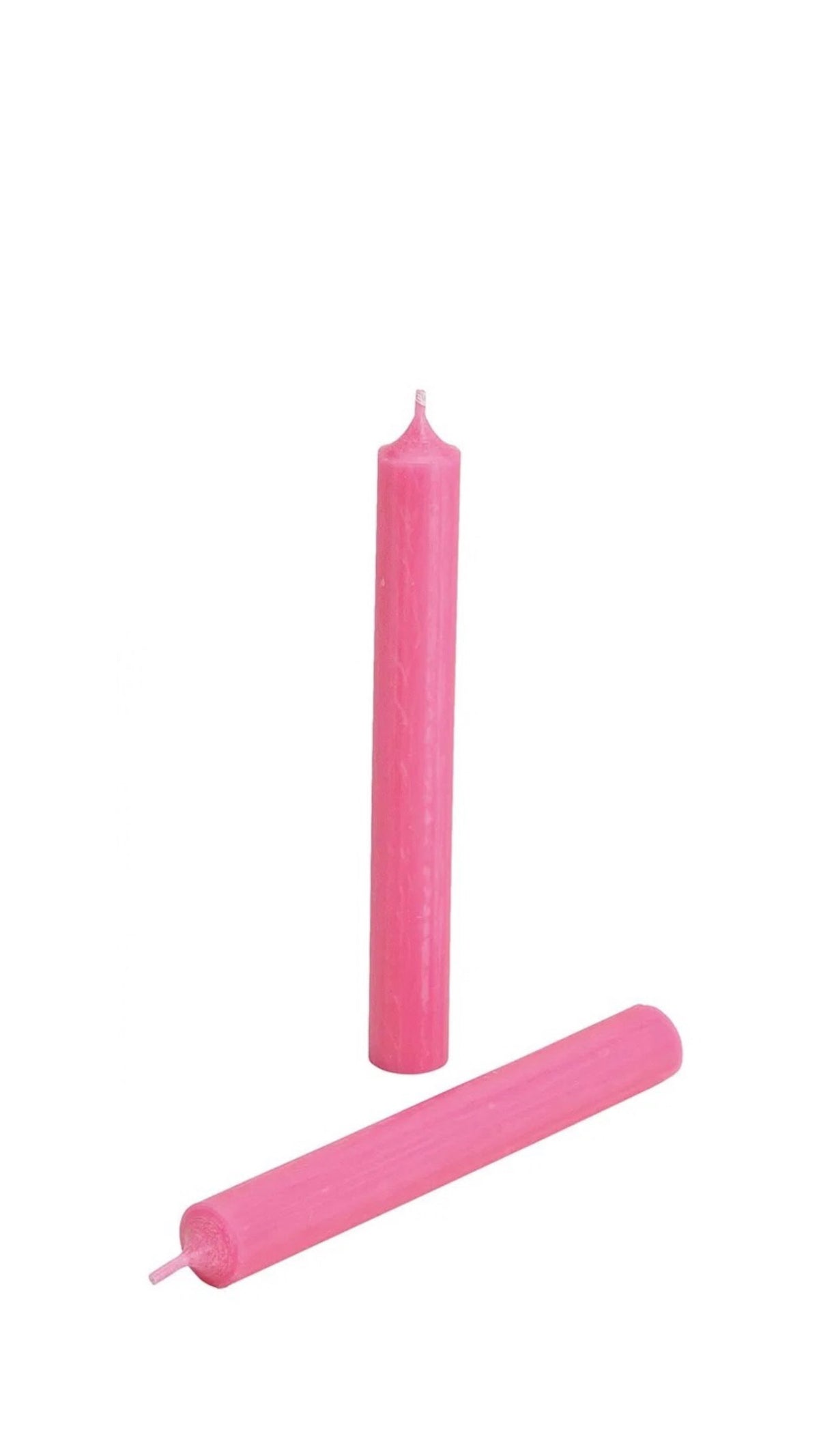 A pink colored candle on a white background.