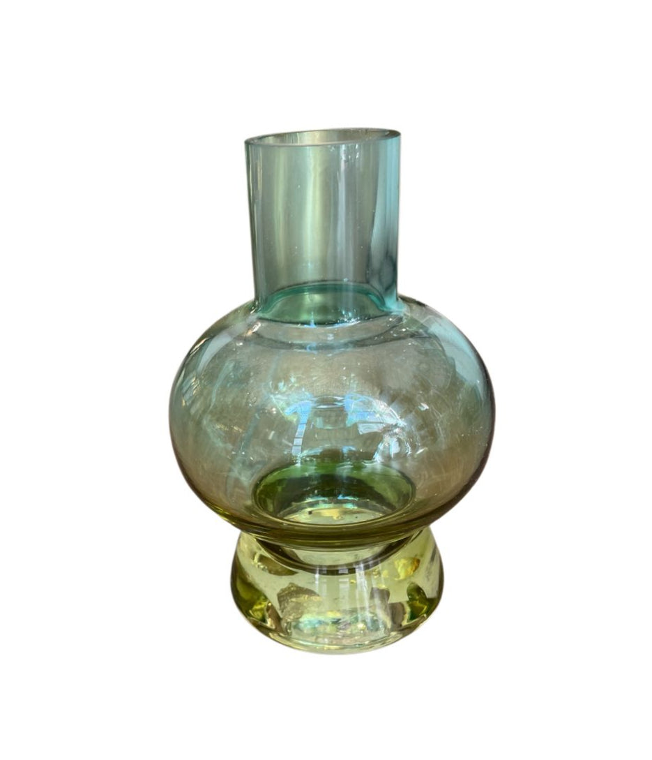 Glass vase with a gradient color from green to clear on a white background