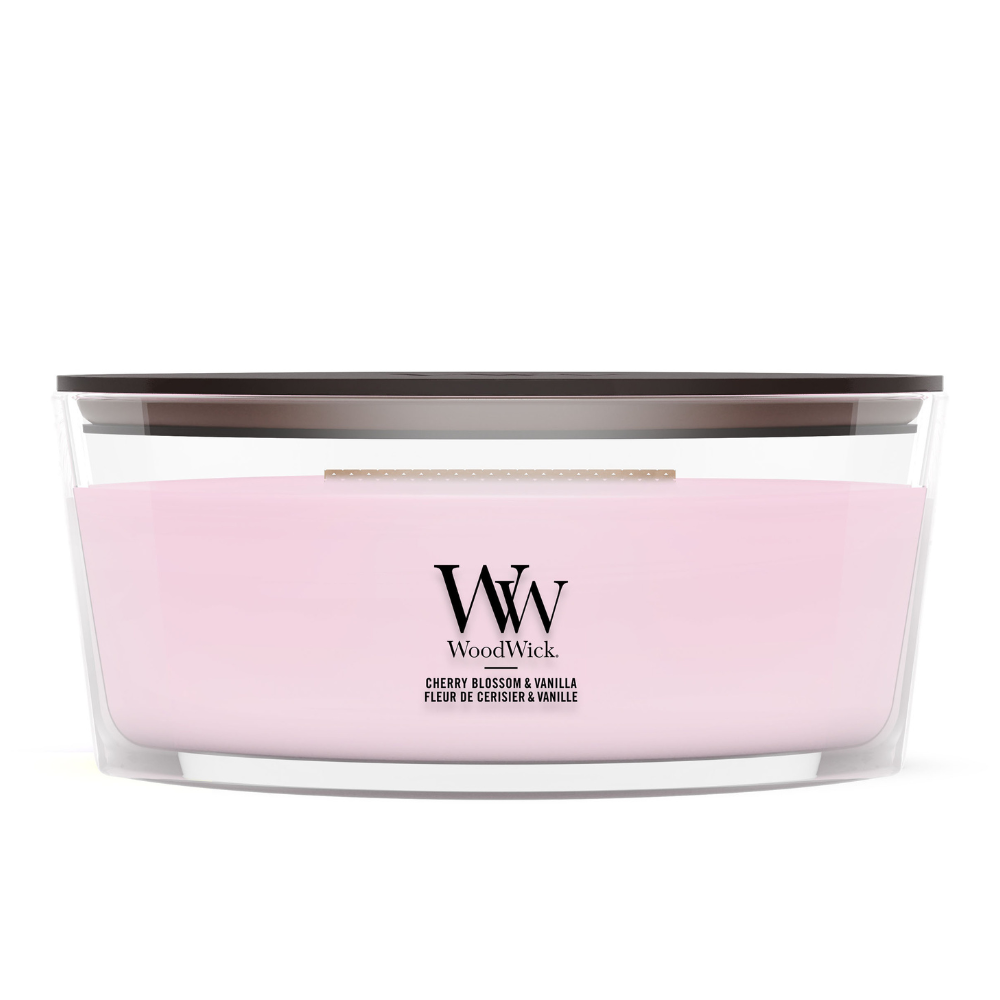 WoodWick Cherry Blossom & Vanilla candle in a clear glass jar with a wooden lid.