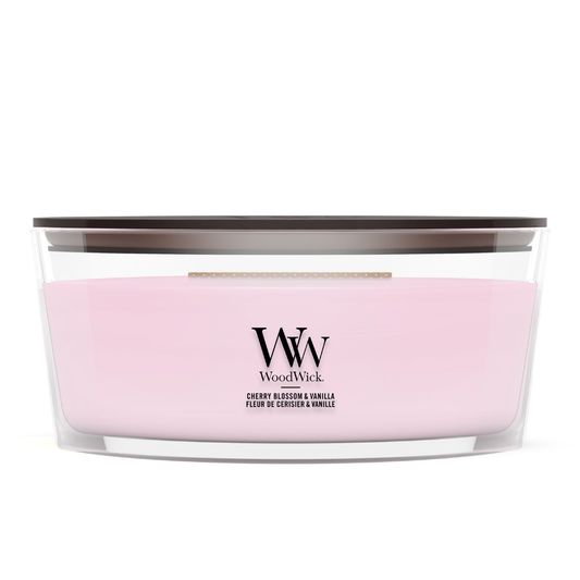 WoodWick Cherry Blossom & Vanilla candle in a clear glass jar with a wooden lid.