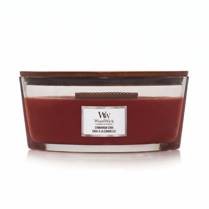 WoodWick Cinnamon Chai candle in a clear glass jar with a wooden lid.