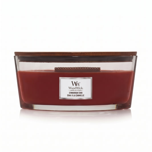 WoodWick Cinnamon Chai candle in a clear glass jar with a wooden lid.