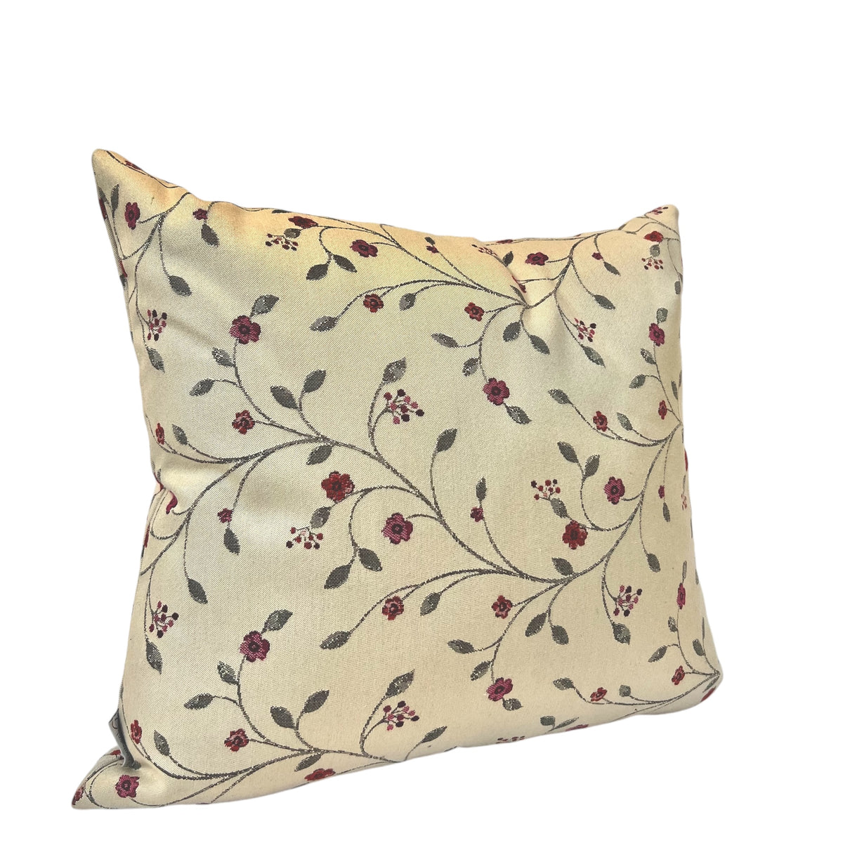 Square cream throw pillow featuring a delicate red and green floral vine pattern against a plain white background.