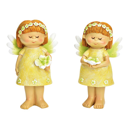 Two ceramic figurines of fairies, one in a yellow dress with a green flower, and the other in a green dress with a yellow flower.
