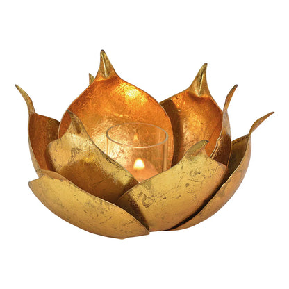 A gold aluminum tealight holder in the shape of a lotus flower with a candle inside.