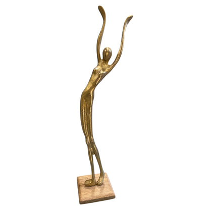Gold metal human stand figure posed on wooden base