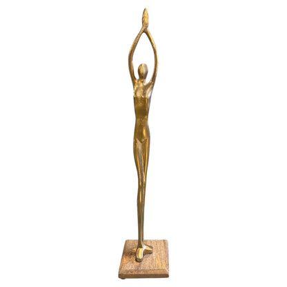 Gold metal human stand figure posed on wooden base