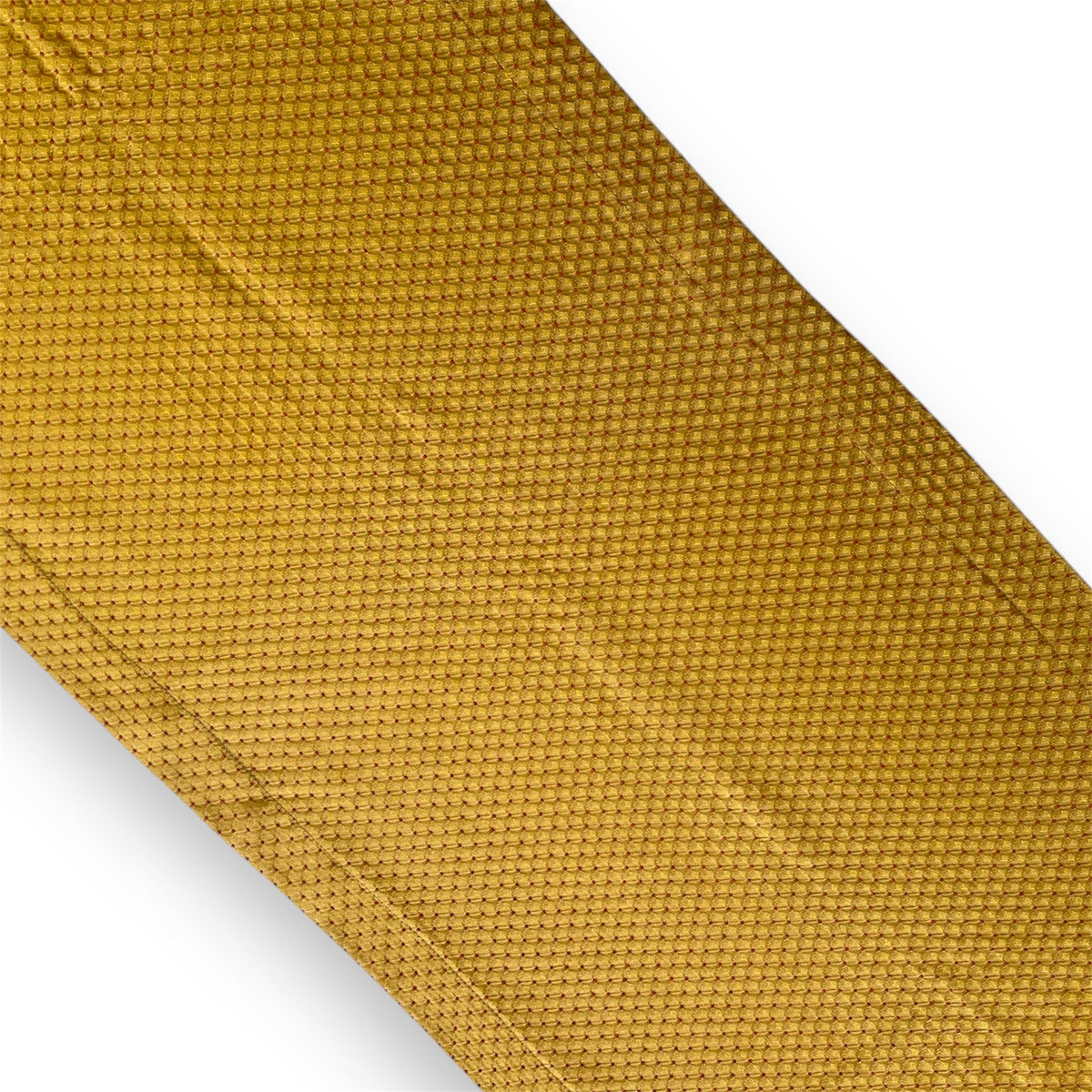 A close-up image of a golden yellow geometric patterned table runner.