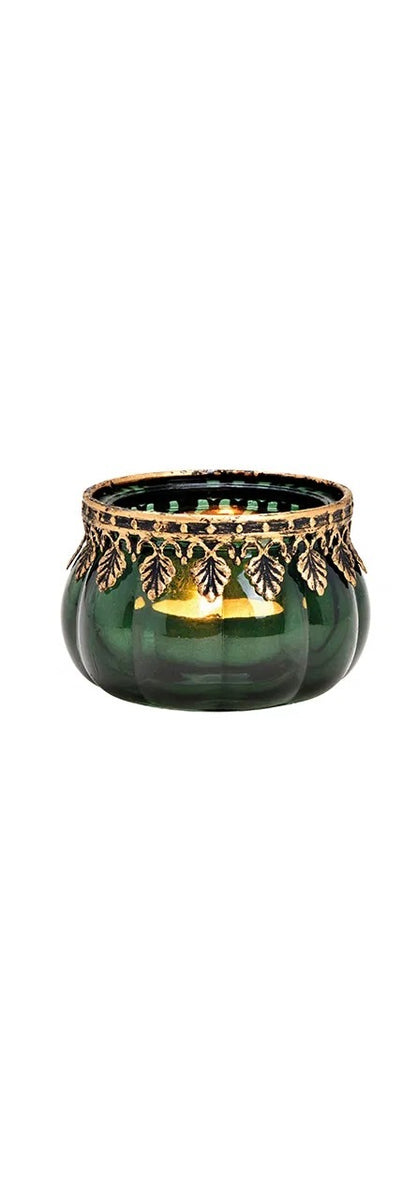 one green glass candle holder with metal decoration, displayed against a white background.