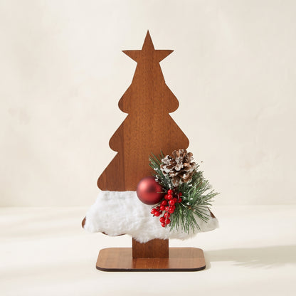 Handmade wooden star Christmas tree centerpiece decorated with pine branches, pinecones, and a white-red holiday ornament.