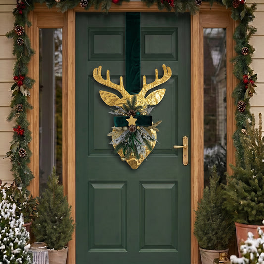 Handcrafted two-sided golden deer holiday door hanger featuring a festive red plaid tartan ribbon, frosted pine branches, pinecones, berries, and a golden bell, hanging on a classic green front door