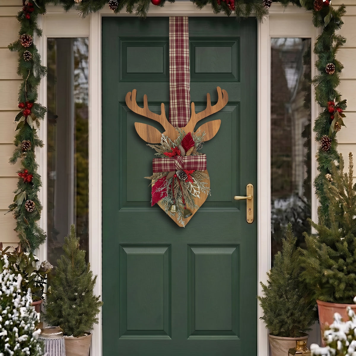 Handcrafted two-sided wooden deer holiday door hanger featuring a festive red plaid tartan ribbon, frosted pine branches, pinecones, berries, and a golden bell, hanging on a classic green front door