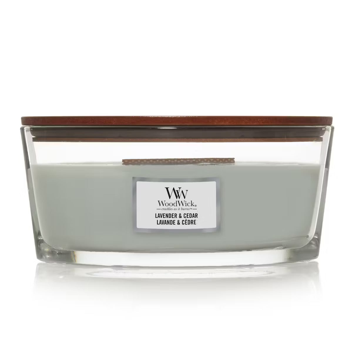 WoodWick Lavender & Cedar Ellipse Jar Candle with light sage green wax, a wooden wick, and a wooden lid centered against a clean white background.