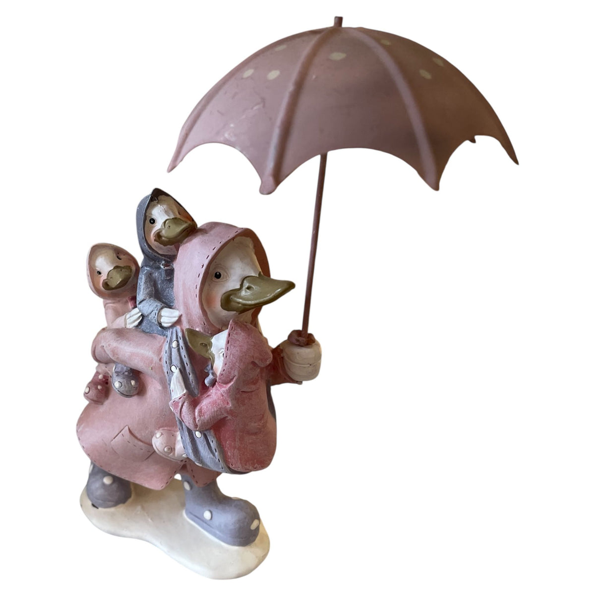 Statue of two ducks in pink raincoats with an umbrella on a white background