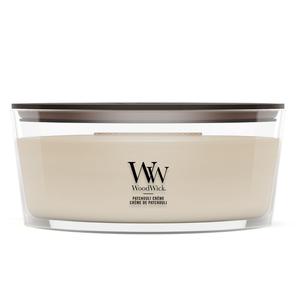 WoodWick Patchouli Crème candle in a clear glass jar with a wooden lid.