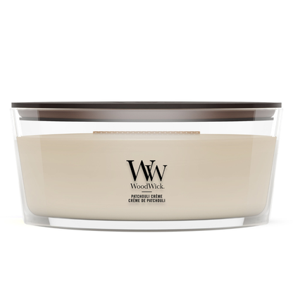 WoodWick Patchouli Crème candle in a clear glass jar with a wooden lid.