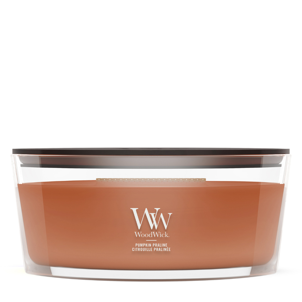 WoodWick Pumpkin Praline candle in a clear glass jar with a wooden lid.