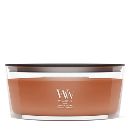 WoodWick Pumpkin Praline candle in a clear glass jar with a wooden lid.
