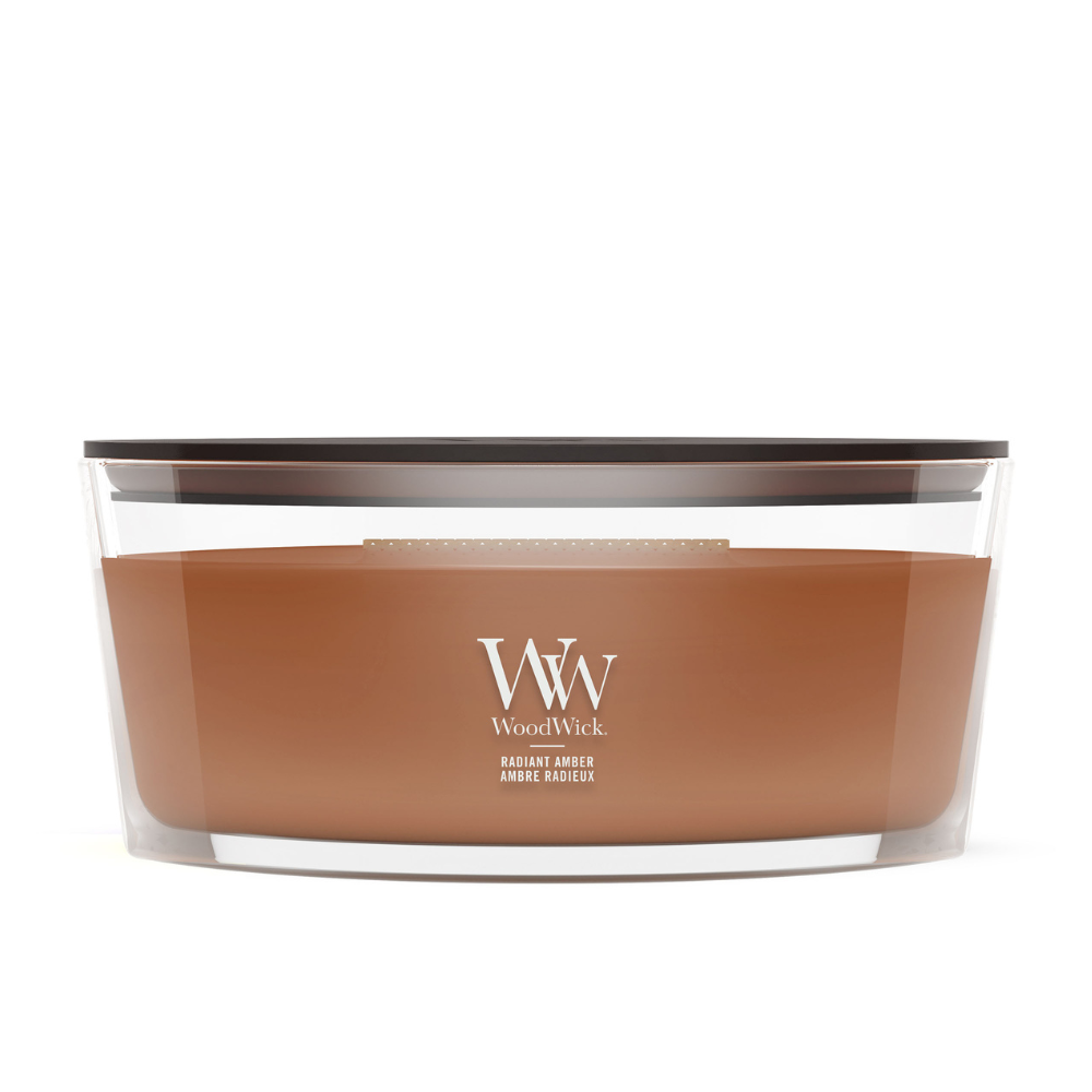 WoodWick Radiant Amber candle in a clear glass jar with a wooden lid.