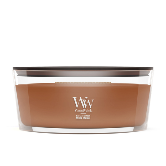 WoodWick Radiant Amber candle in a clear glass jar with a wooden lid.