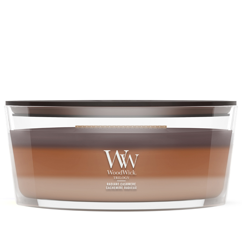 WoodWick Radiant Cashmere trilogy ellipse candle in a clear glass jar with a wooden lid.