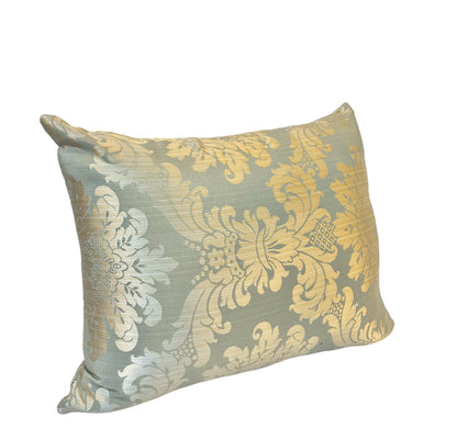 Rectangular light blue and gold throw pillow featuring an ornate floral damask pattern against a white background.