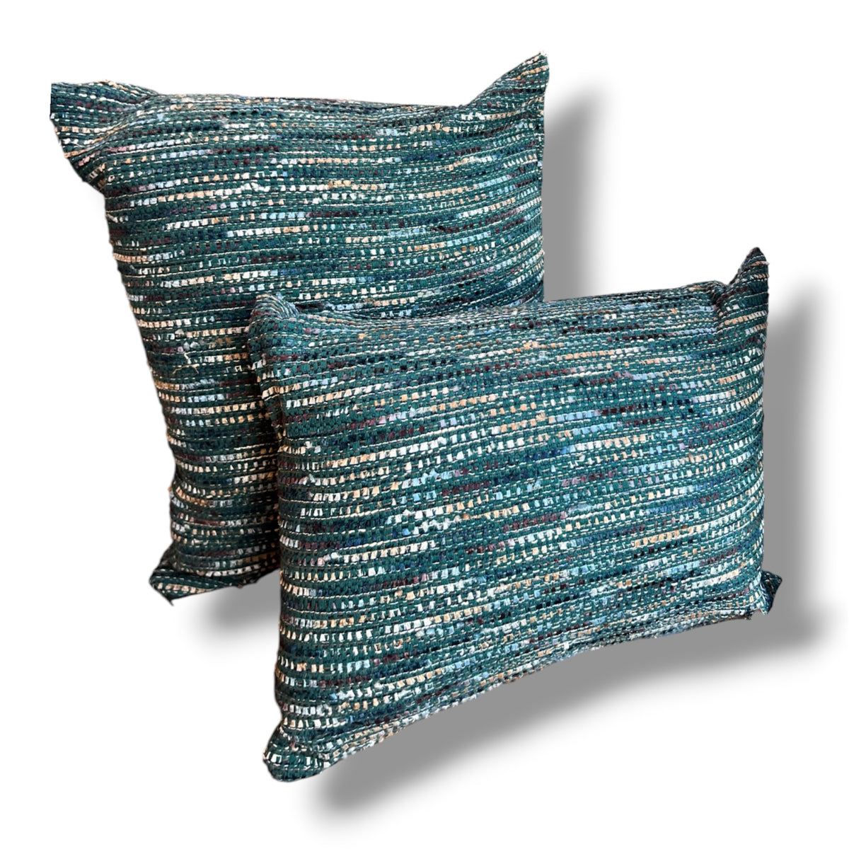 Set of two textured tweed decorative pillows, featuring a rectangular lumbar pillow in front of a matching square cushion in woven ocean teal, emerald green, navy, and metallic silver threads against a plain white background.