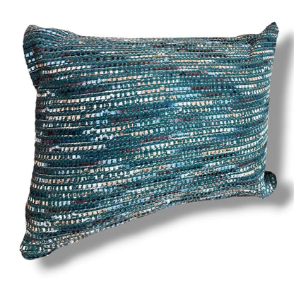 Rectangular textured tweed lumbar throw pillow in a rich woven pattern of ocean teal, emerald green, navy, and metallic silver threads against a plain white background.