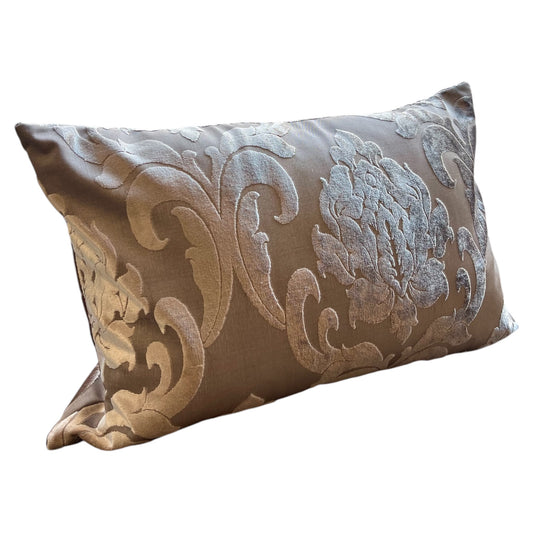 A rectangular throw pillow with antique pink and silver floral bloom pattern.