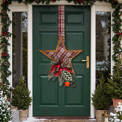 Handcrafted red plaid two-sided star holiday door hanger accented with frosted pine branches, pinecones, berries, and a festive red bow, hanging on a dark green front door.