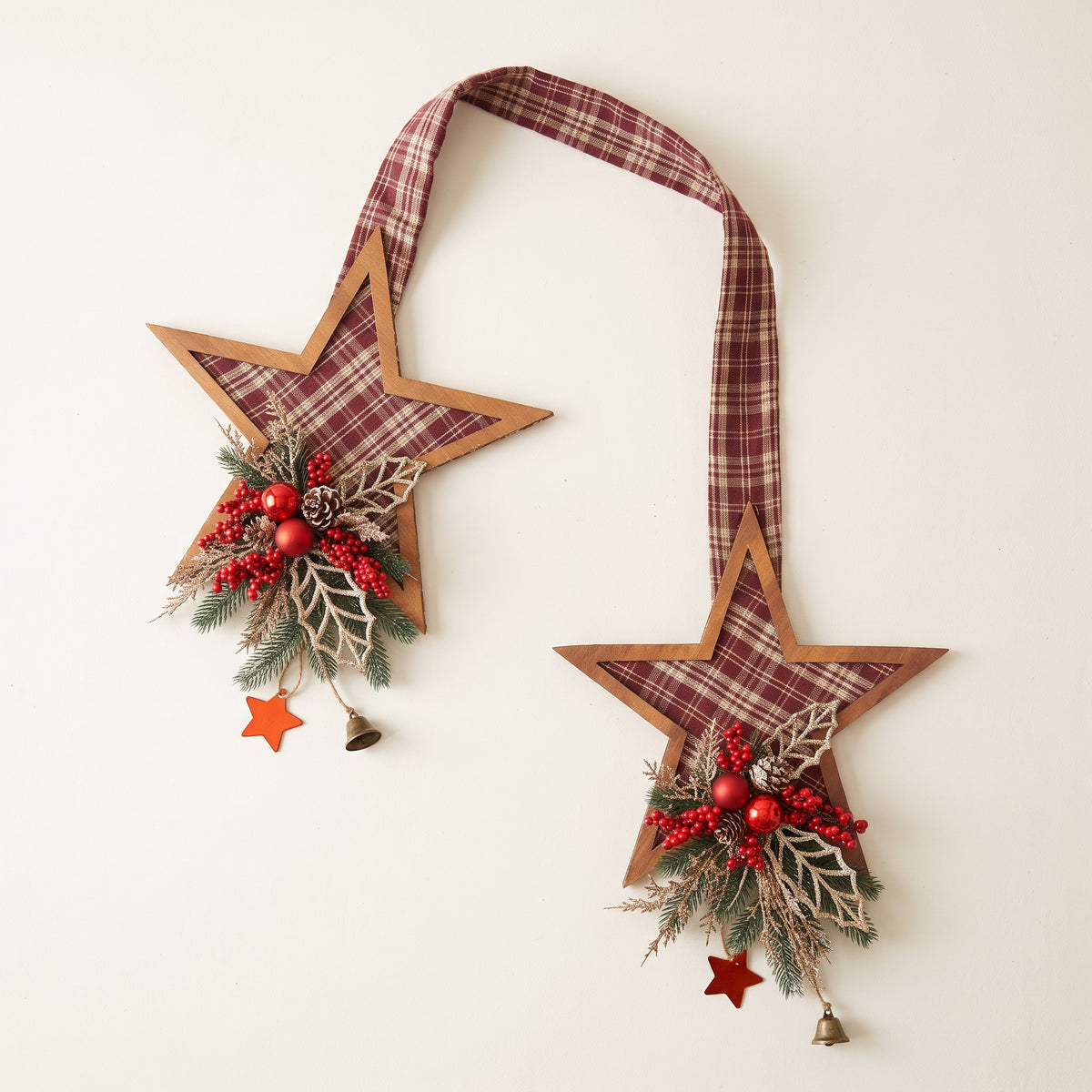 Handcrafted red plaid two-sided star holiday door hanger accented with frosted pine branches, pinecones, berries, and a festive red bow, against white background